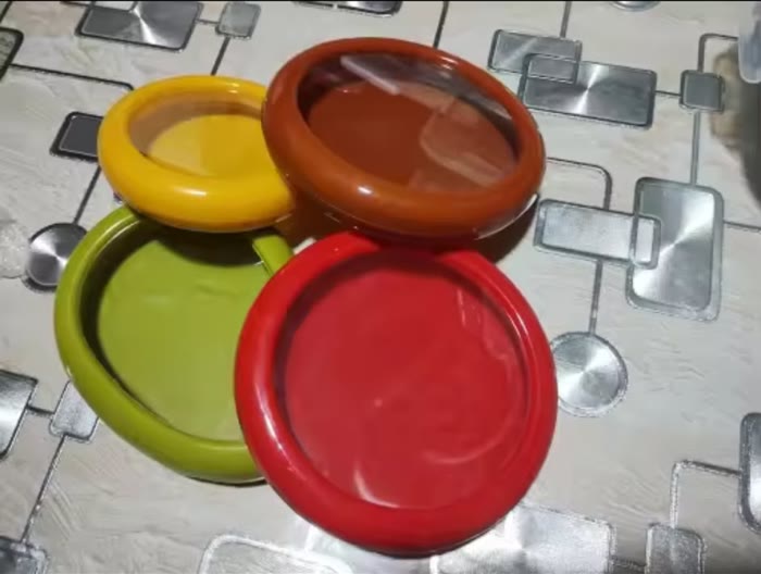 Four pods on a tiled kitchen floor